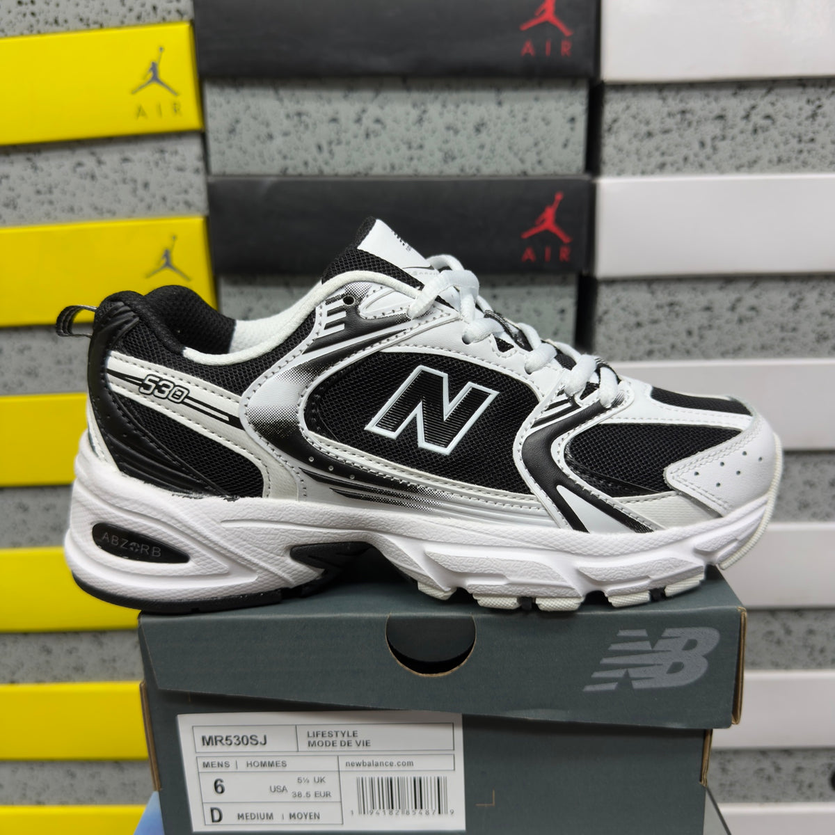 Baskets running blanches et noires pour homme